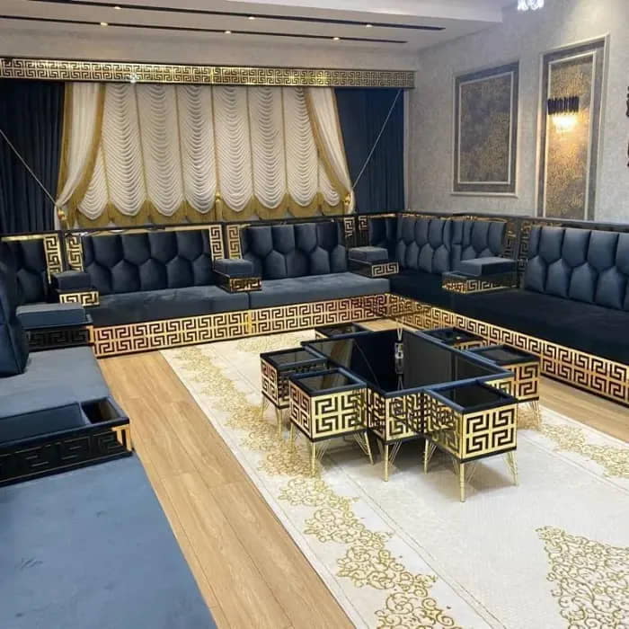 A-stylish-black-and-gold-majlis-sofa-featuring-plush-seating-decorative-throw-pillows-and-a-unique-coffee-table-setup (1)